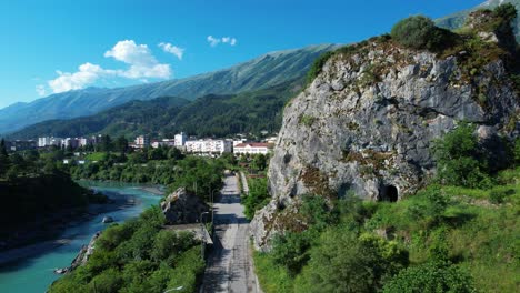 permet city revealed peacefully behind majestic rock by vjosa river on tranquil morning panorama