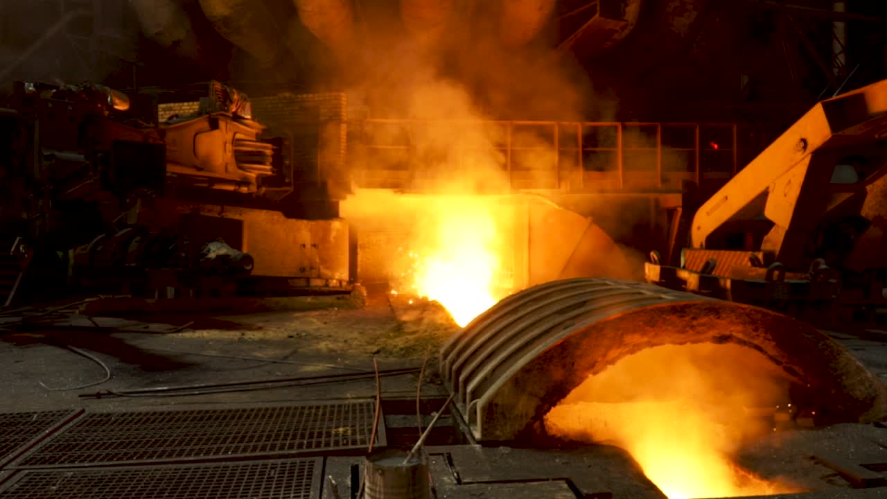 Metal Foundry Workers Pouring Molten Metal