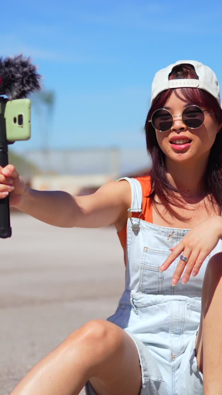 Woman vlogging outdoors with her phone