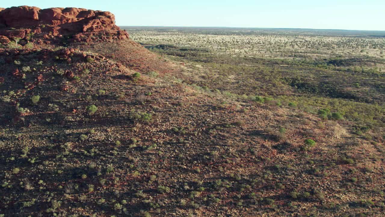 Aerial footage flying over a ridge near Kings Canyon, Watarrka, in the Northern Territory, Australia. August 2022.