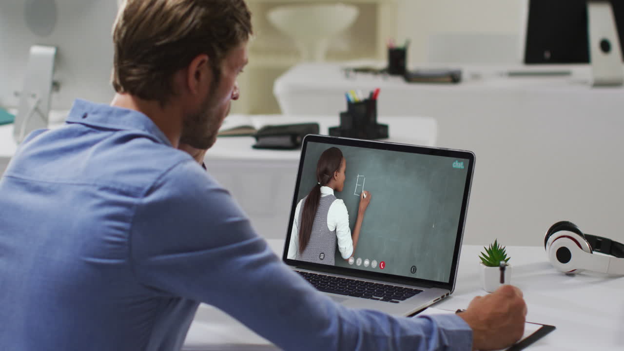 Caucasian male student using laptop on video call with female teacher