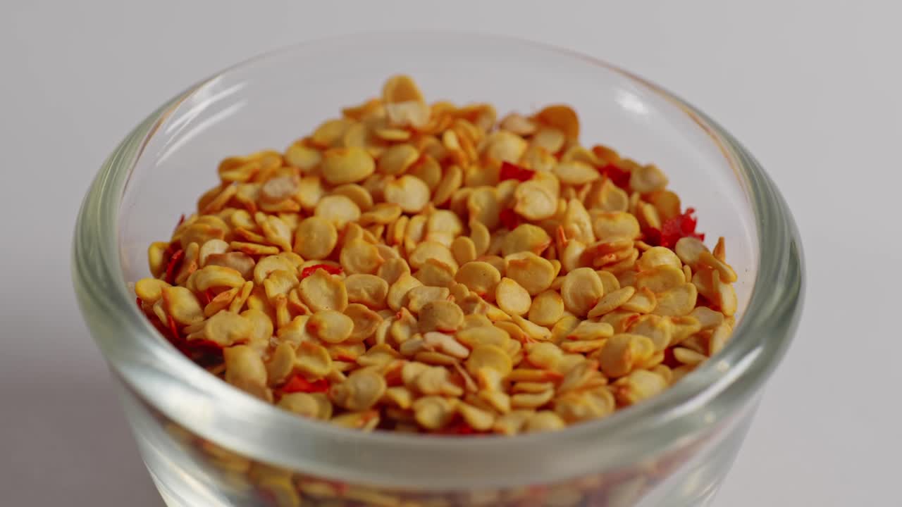 chilli Flakes in small glass bowl, closeup, 4k, parallax shot.