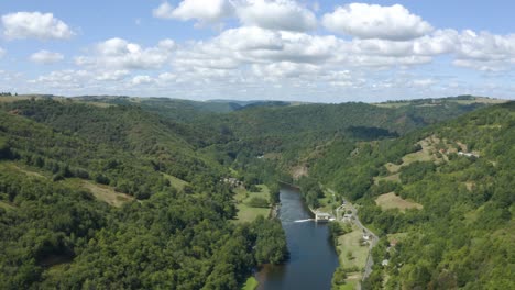 Aerial-view-drone-flying-above-French-green-woodland-Lot-river-landscape