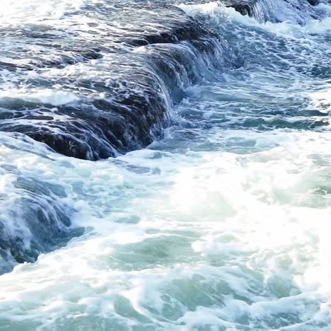wave breaking on rocks