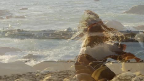 animation of landscape over caucasian woman at beach