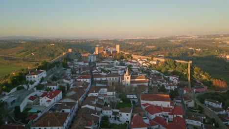 panoramic view old town with ancient castle walls at evening light aerial shot