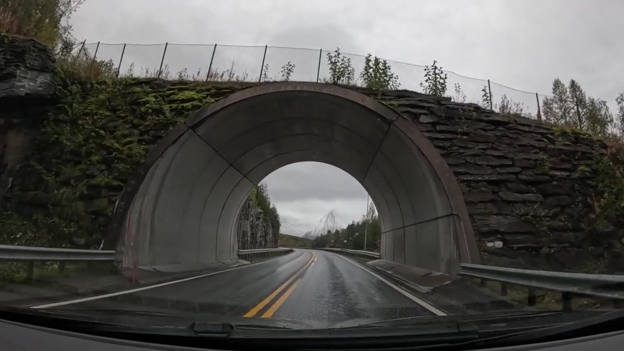 Scenic drive through the rainy mountain roads near Tromsø, Norway, captured from a GoPro Hero 12 attached to a car window. The footage showcases the dramatic natural beauty of Northern Norway.