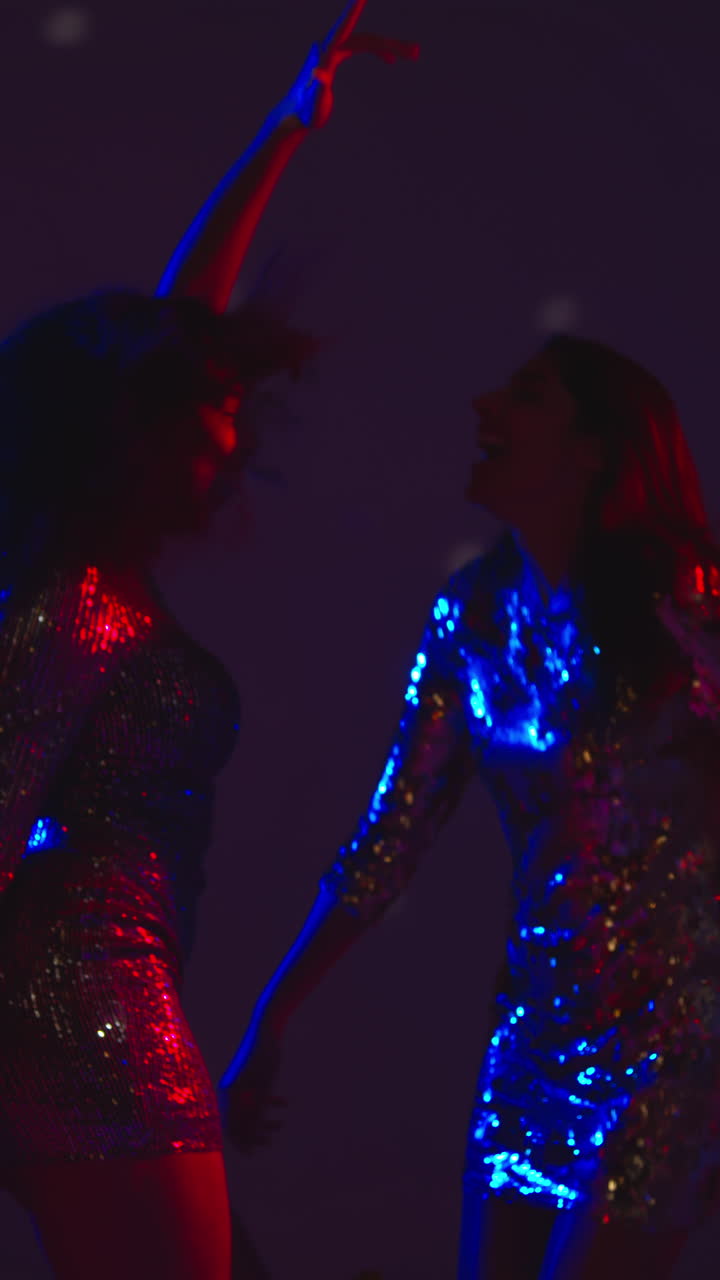 Vertical Video Of Two Women In Nightclub Bar Or Disco Dancing With Sparkling Lights In Background