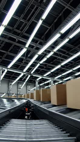 Low-angle shot of a conveyor system with boxes, highlighting industrial efficiency