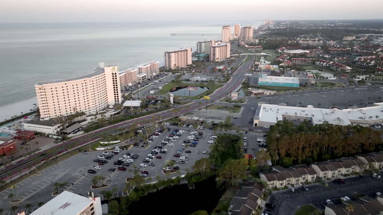 Condos, homes and hotels in Panama City Beach, Florida with drone moving in slowly.
