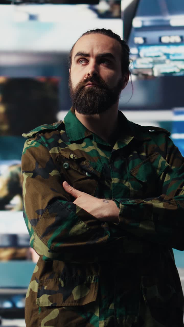 Vertical Video Young soldier working in command center with satellite surveillance