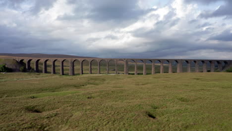 aerial shot flying forwards through ribblehead viaduct in the yorkshire dales national park