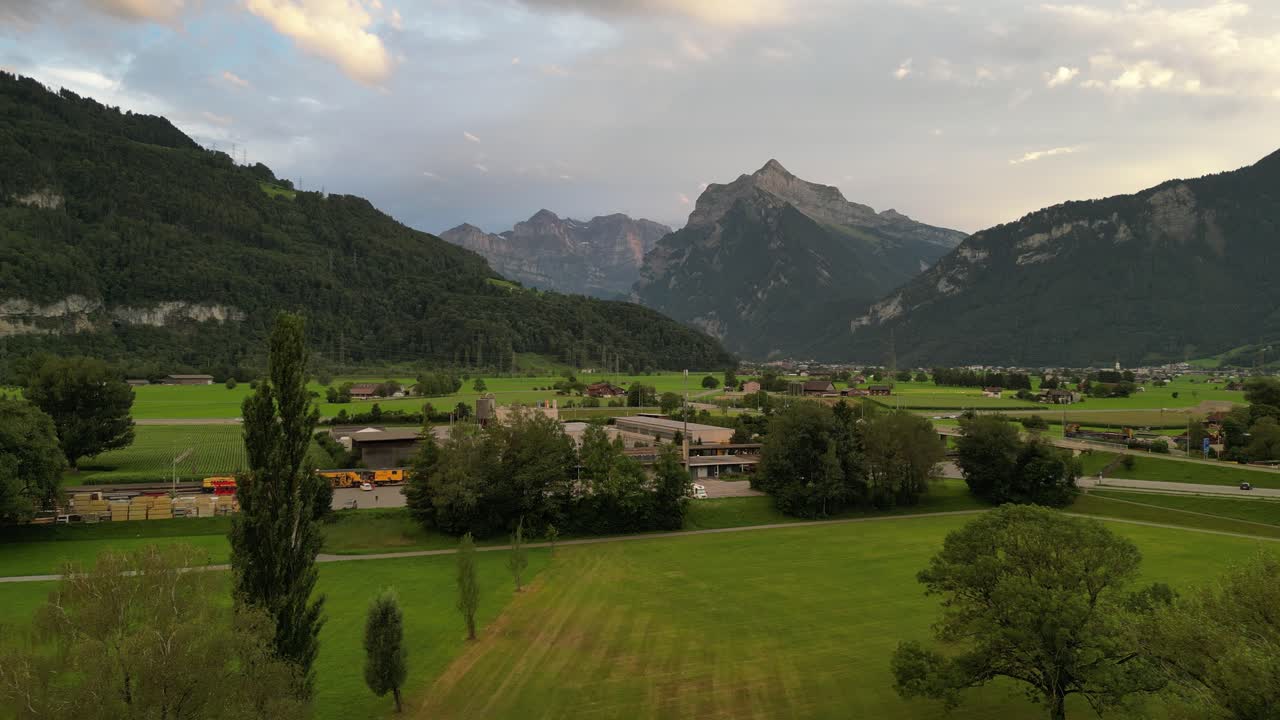 lugar increíble en el campo con montañas gigantescas superficie desigual bordes afilados en el medio de la nada estación de tren con tren amarillo naranja en el soporte por el transporte área tranquilizadora