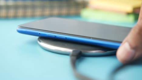 wireless charging of a blue smartphone