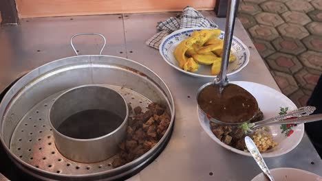 soto lamongan seller prepares a menu at his stall, batang indonesia