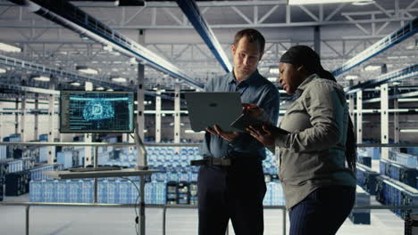 team of data center programmers monitoring deep learning processes with laptop