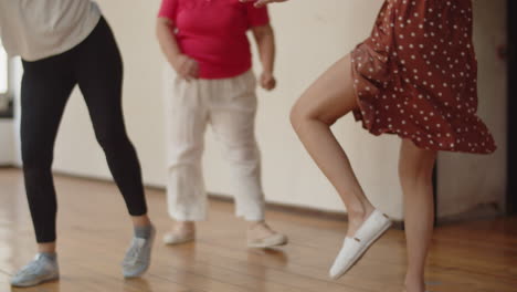 medium shot of women's legs dancing boogie-woogie in ballroom