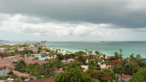 antigua and barbuda - 2023: aerial view beautiful caribbean island coastline panorama with villa houses and sandy beach with boats on shore