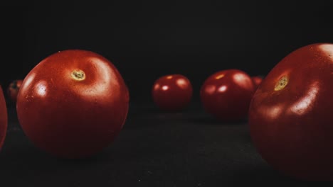 zooming in on multiple tomatoes ending with a few on vines