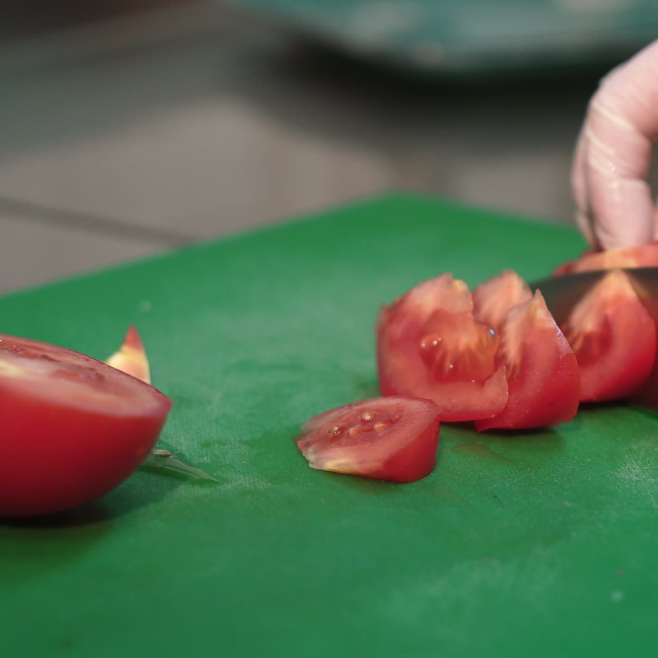 Hands cutting tomatoes