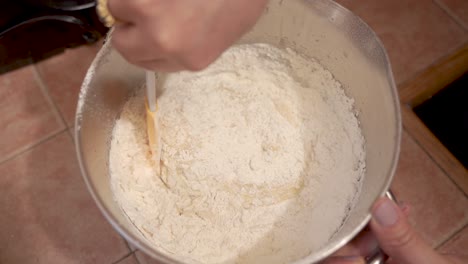 mixing flour and beaten eggs for the cake batter