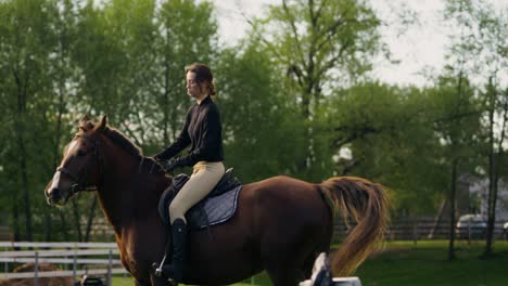 woman riding a horse in a countryside setting