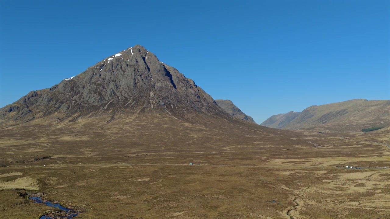 Aerial footage of Glencoe in the Highlands of Scotland. Drone shot looking up the glen towards Fort William. Stob Dearg, Buachille Etive Mor are visible in the foreground.