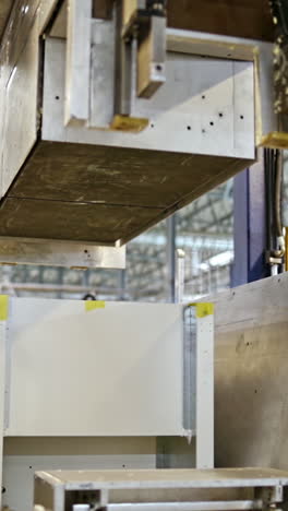 innovative factory background. robotic equipment inside the modern plant. process of making new detail by modernized equipment. vertical video