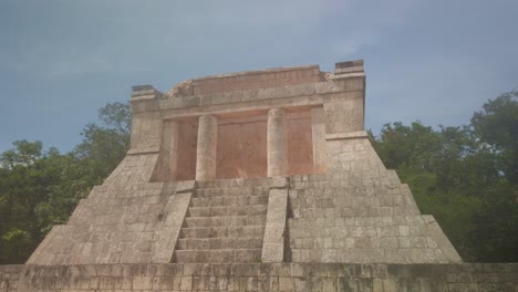 gimbal booming down shot of the north temple or temple of the bearded man at the great mayan ball court in chichen itza, mexico. 4k