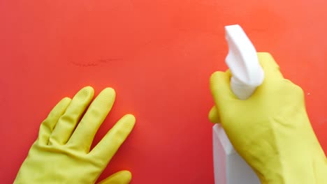 hand in yellow rubber gloves holding spray bottle with copy space ,