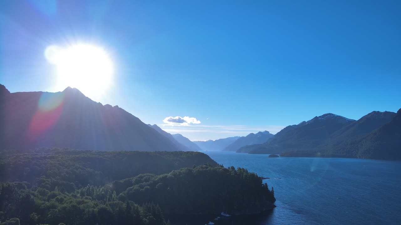 Solar glow in the mountains over the lake in Villa Tacul, Patagonia, Argentina. Drone shot.