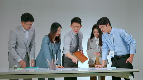 in-depth analysis and collaborative discussion over pie charts and bar graphs in a business meeting. smart professional team collaborating, reviewing financial data, strategizing marketing plans