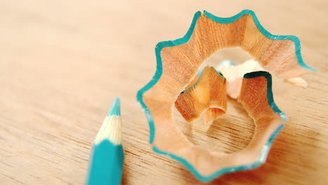 close-up of green colored pencil with shavings