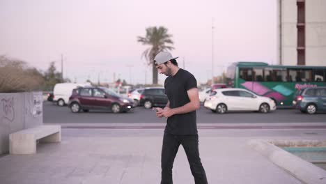 man walking in city street using phone