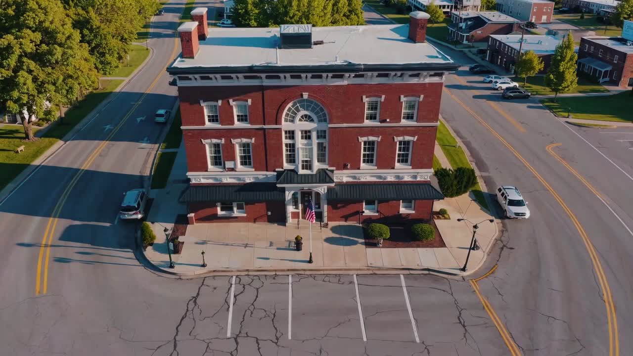 Aerial view of a historic brick building with elegant architecture, showcasing its detailed facade and surrounding streets, capturing the essence of urban charm and architectural beauty