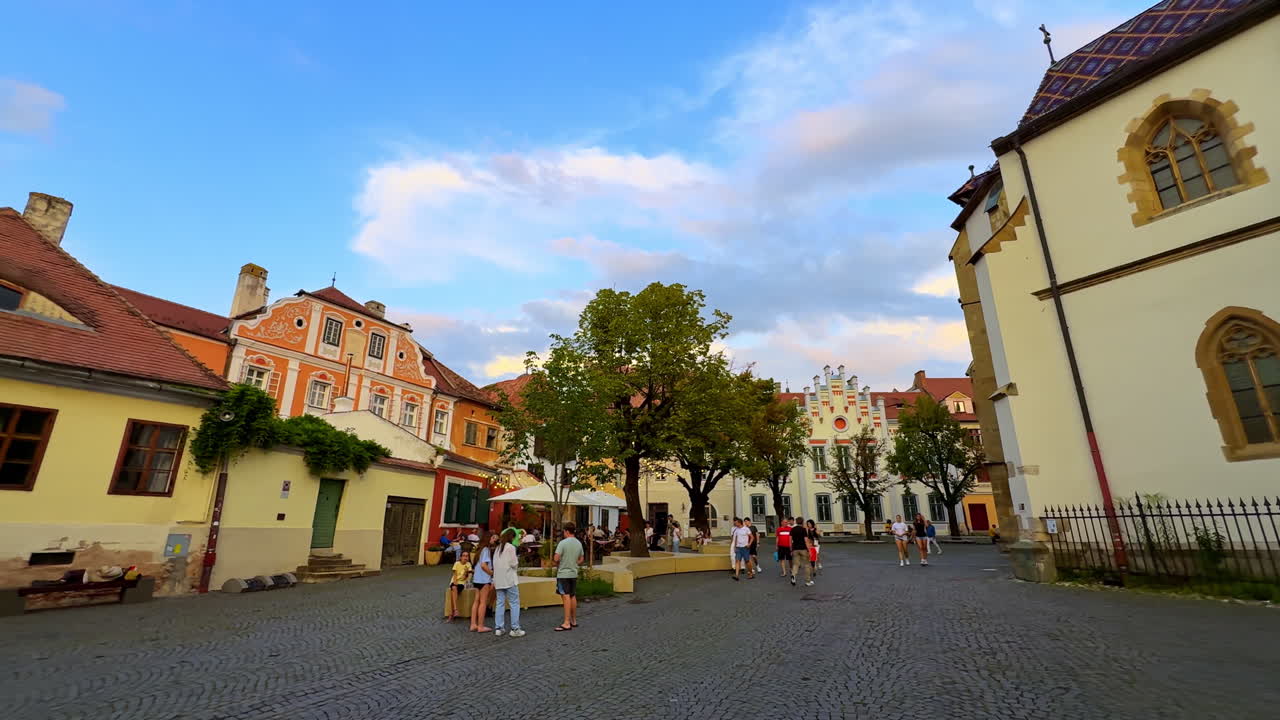 Sibiu, Romania, 1 July 2025: Colorful Square in Sibiu Old Town. Historic colorful houses and lively atmosphere in Sibiu, Romania, with people enjoying the evening in the old square