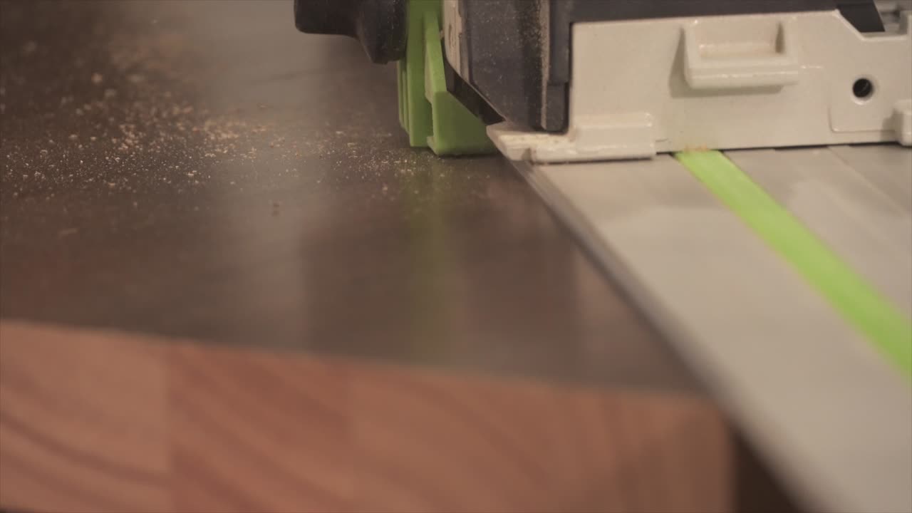 Cutting a piece of wood with a saw.