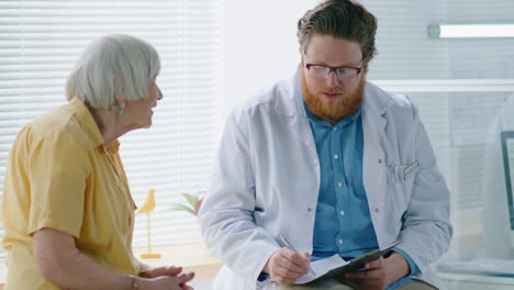 senior woman consulting with doctor in clinic