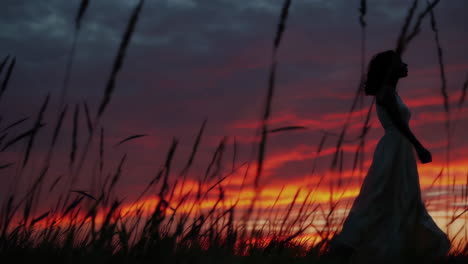 woman silhouetted at sunset
