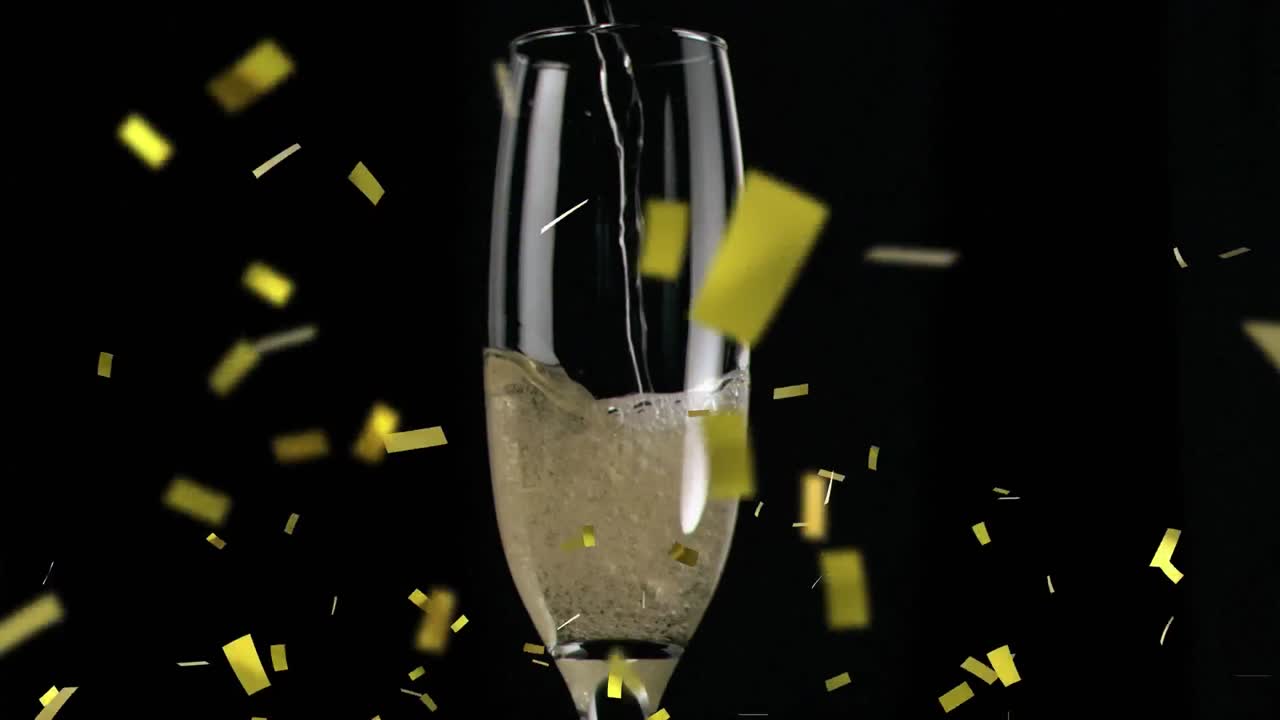 검은색 바탕에  ⁇ 페인 잔 위에 떨어지는 금색 콘페티의 애니메이션