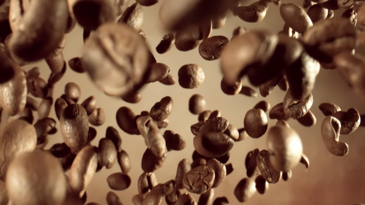 Fragrant coffee beans soar in the frame. Coffee beans shot on super slow motion camera 1000 fps.