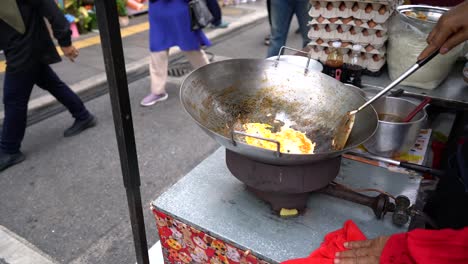 worker cooking pad thai in street food concept