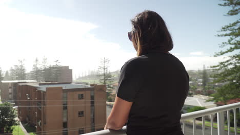 Beautiful-Indian-Woman-Enjoying-Urban-View-From-The-Balcony-Of-A-House-In-Port-Macquarie,-NSW,-Australia