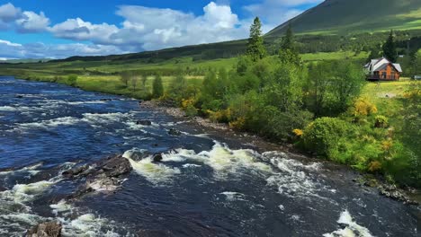 river flowing through scotland's lush countryside - wide shot