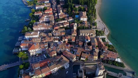 Aerial-view-of-beautiful-cityscape-with-houses-and-forest-surrounded-by-sea