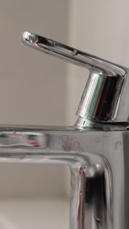 young female opens faucet and washes hands thoroughly slow motion. lady with neat light manicure cleanses body of dirt closeup. woman in washroom