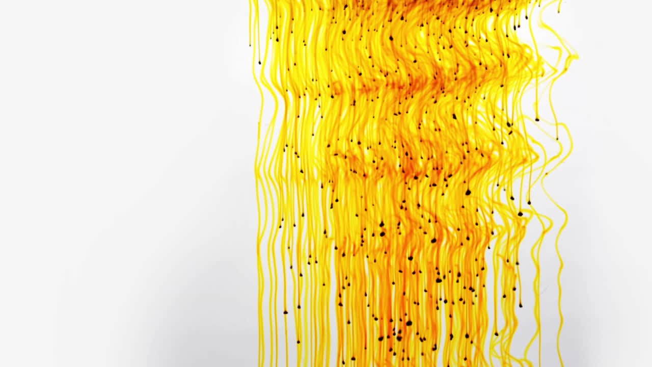 Colorful chemical liquids mix and swirl in water, forming smooth abstract patterns and organic shapes