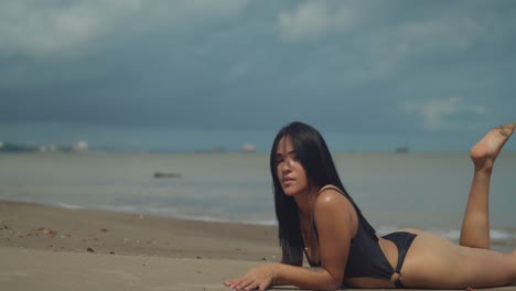 at vessigny beach on the south coast of the tropical island of trinidad, a latina girl enjoys the sun in a bikini