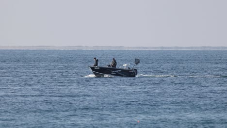 small boat cruising on calm blue waters