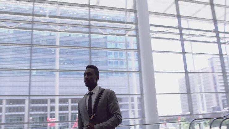 Businessman looking upwards in the lobby at office 4k